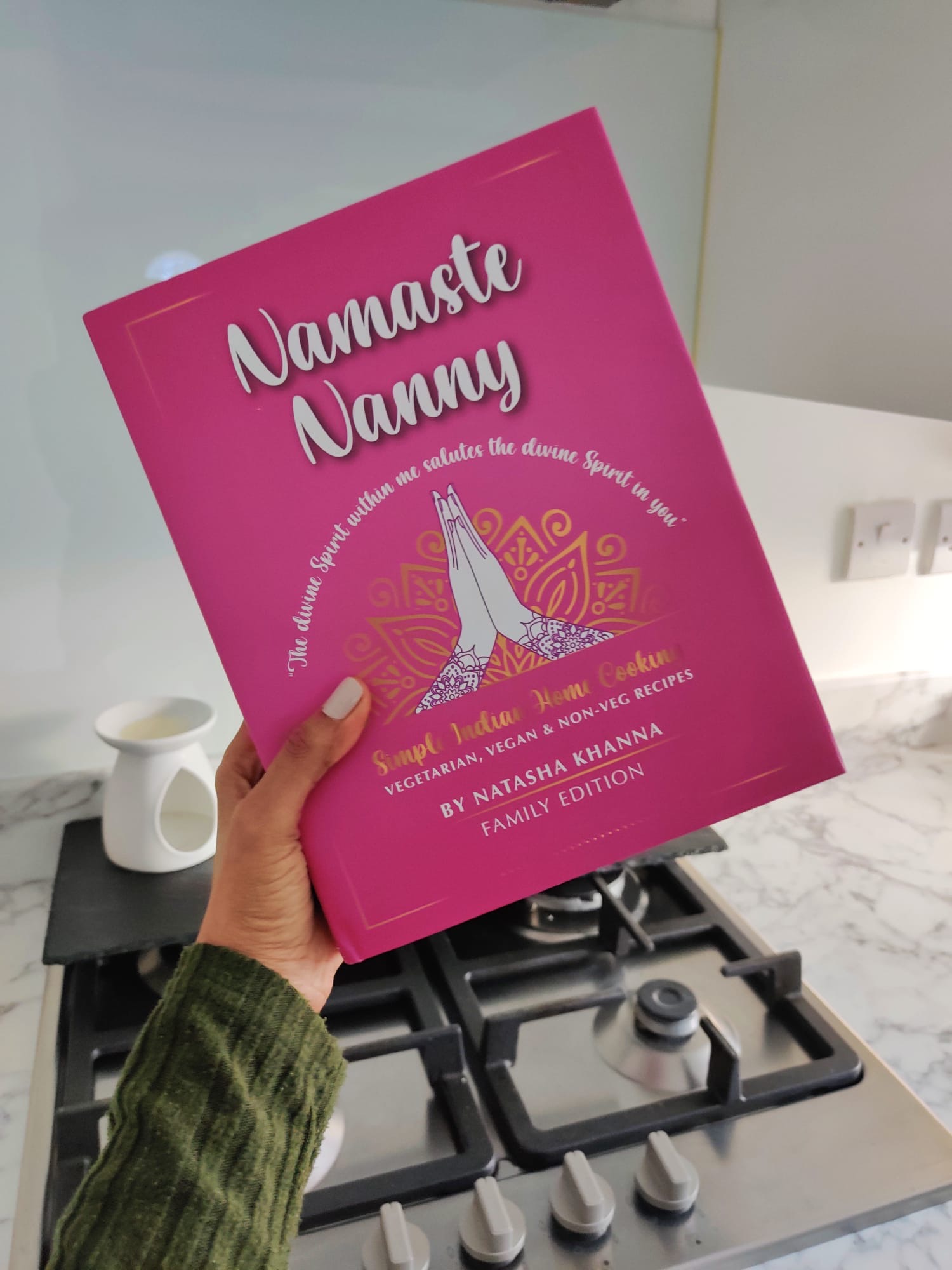 The vibrant pink cover of Namaste Nanny by Natasha Khanna