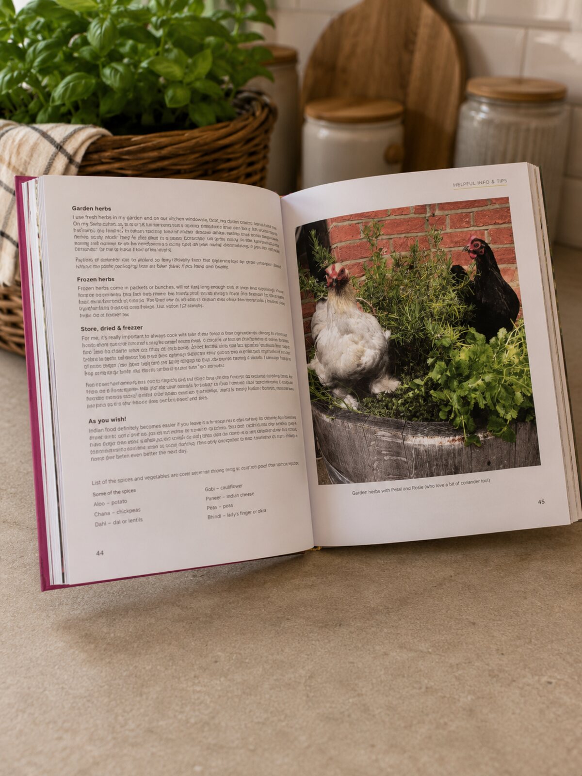 A page about garden herbs, with a photo of two hens among rosemary and coriander